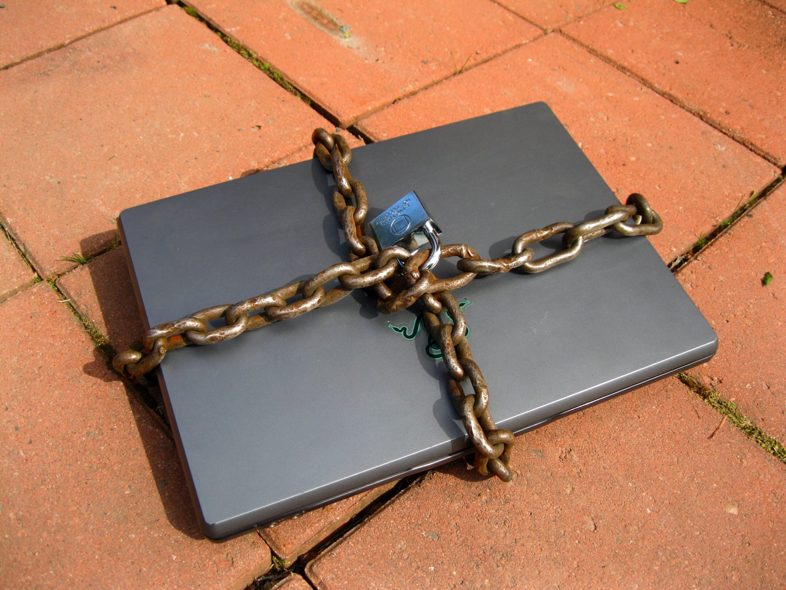 Laptop computer secured with a chain and padlock