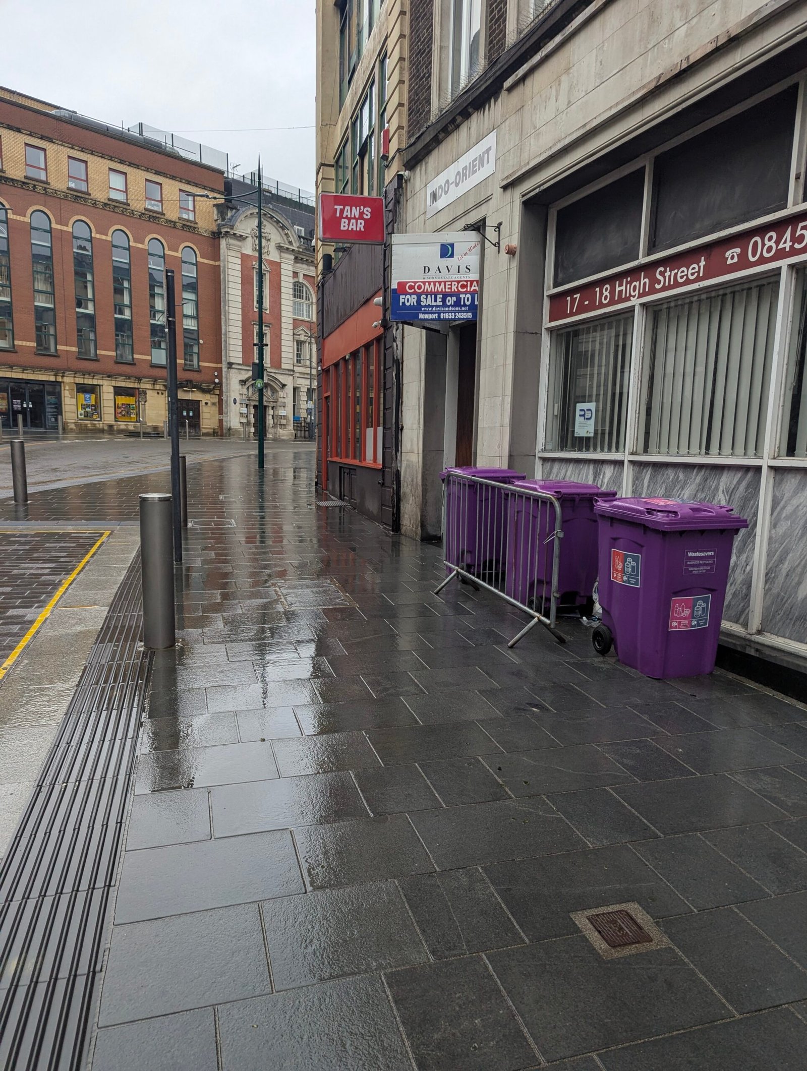 Purple wheelie bins on High Street in Newport, Wales